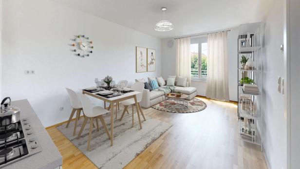 Innenansicht einer kleinen Wohnung, die Küche, Essbereich und Wohnzimmer in einem harmonischen Raum zeigt.
