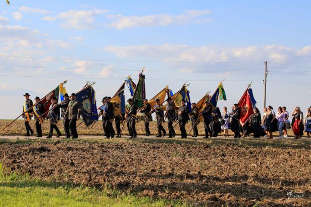 Eine Prozession mit Tracht und Fahnen in Großharras.