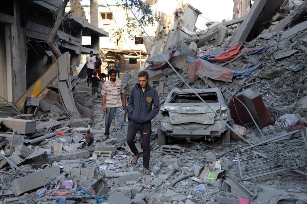 Palestinians inspect the site of Israeli strikes on houses at Shati (Beach) refugee camp in Gaza City