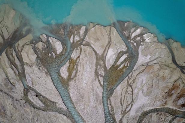 A drone view shows water from melting ice running down from the Turtmann glacier in Turtmann