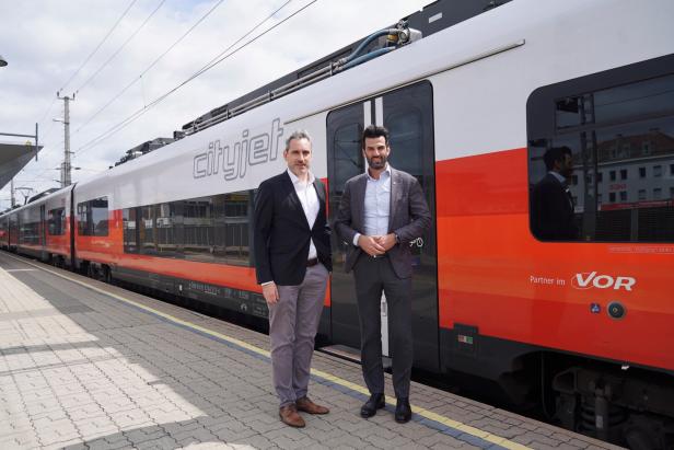 Zwei Männer stehen vor einem Zug.