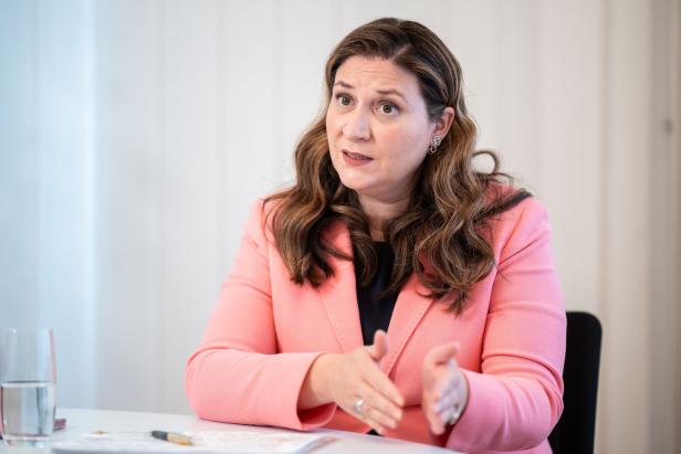 INTERVIEW: FINANZSTADTRÄTIN NOVAK (SPÖ) Eine Frau mit braunen, gewellten Haaren und einem rosa Blazer gestikuliert während eines Gesprächs.