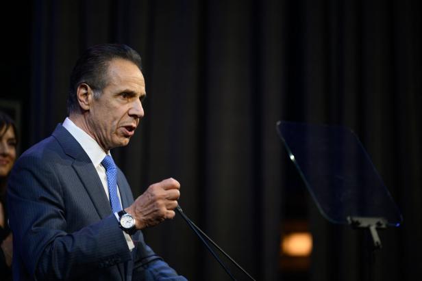 Ein Mann im Anzug spricht gestikulierend an einem Rednerpult mit Mikrofon und Teleprompter.