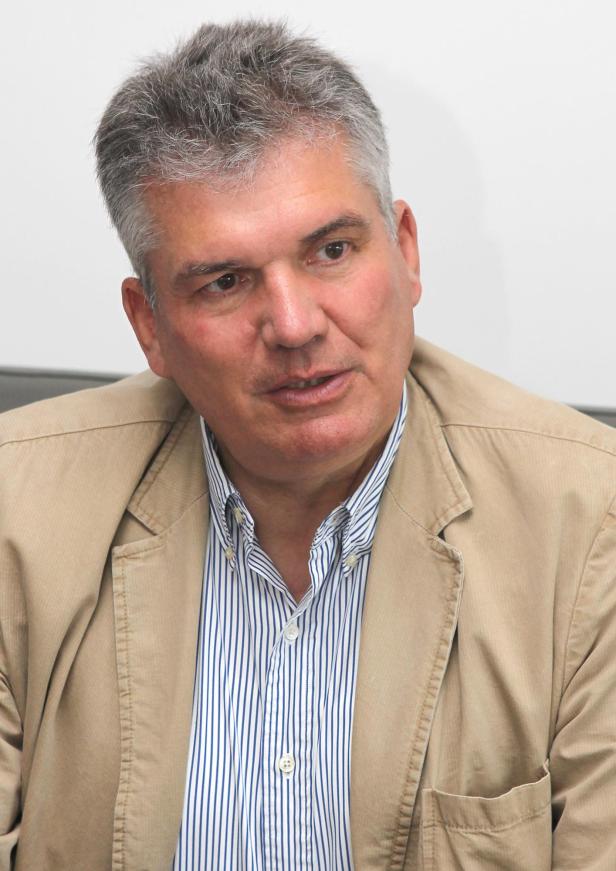 Mann mit grauen Haaren beim Interview