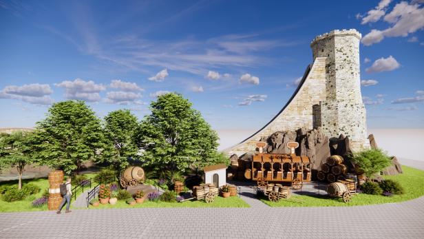 Ein Turm aus Stein steht neben Bäumen und einem Wagen mit Fässern unter blauem Himmel.