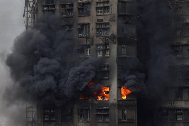 Thick smoke billows from the upper floors of a residential block at Wang Fuk Court housing estate during a major fire that engulfed bamboo scaffolding across multiple buildings, in Tai Po, Hong Kong