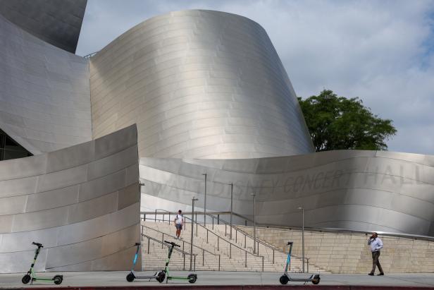 People walk outside the Walt Disney Concert Hall in Los Angeles