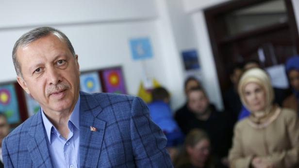 Turkey's PM Erdogan prepares to leave a polling st