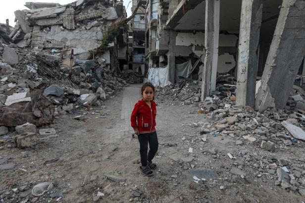 Displaced Palestinian families shelter among the ruins of their homes
