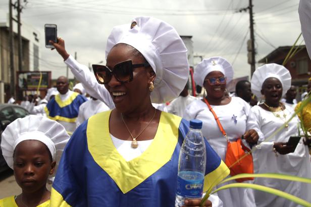 Celestial Church of Christ members participate in a procession during Palm Sunday
