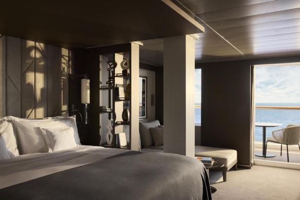 Luxuriöse Suite mit modernem Design, großem Bett und privater Terrasse mit Meerblick.