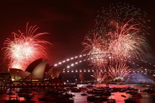 Fireworks explode over Sydney Harbour Bridge at 9 p.m. during New Year's Eve celebrations, in Sydney