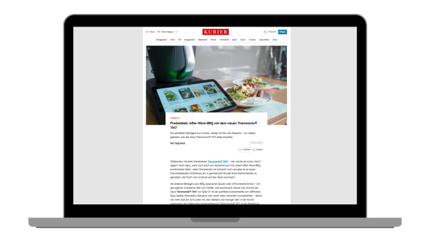 Auf einem Laptop-Bildschirm ist ein Online-Artikel des KURIER mit einem Produkttest zum Thermomix TM7 und passenden Grillrezepten zu sehen.