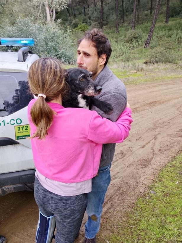 Ana Garcia Aranda hugs her dog 'Boro' after it was rescued by Andalusia regional firefighters days after the deadly derailment of two high-speed trains, in Adamuz