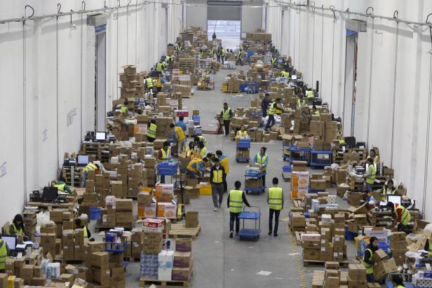 Employees sort boxes and parcels at the logistics centre of a express delivery company, after the Singles Day online shopping festival, in Wuhan
