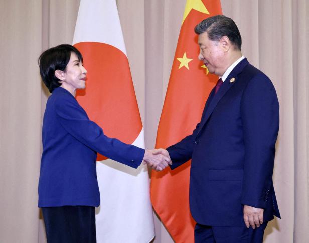 FILE PHOTO: Japanese Prime Minister Sanae Takaichi shakes hands with Chinese President Xi Jinping ahead of their talks in Gyeongju, South Korea