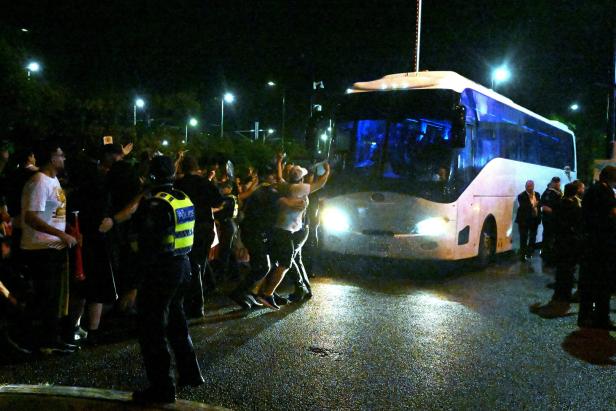 People attempt to block a bus transporting Iranian players following the AFC Women's Asian Cup Group A match between Iran and Philippines at Gold Coast Stadium