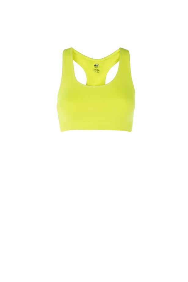 Ein neon-gelber Sport-BH von H&M vor einem weißen Hintergrund.