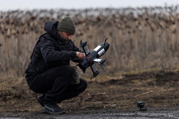 Ukrainian serviceman prepares an FPV interceptor drone for a launch during his combat shift in Kharkiv region