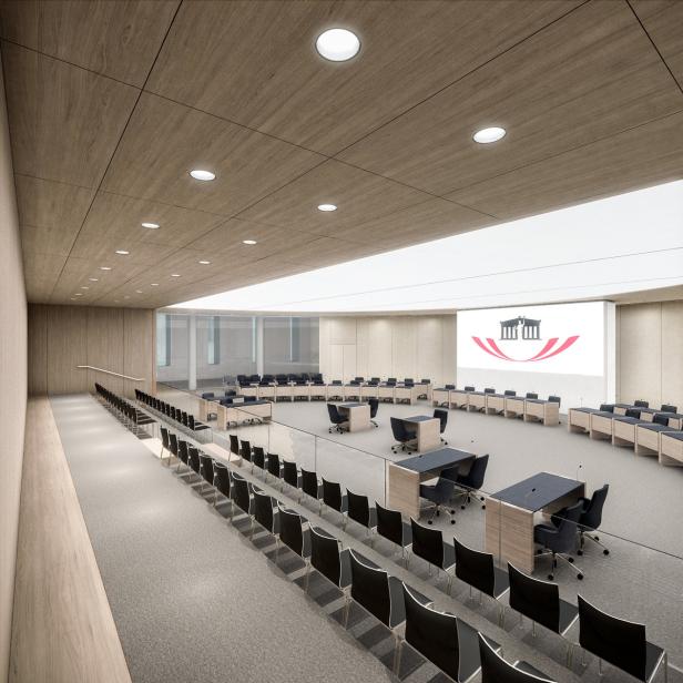 Ein großer Konferenzraum mit Tischen, Stühlen und einer Leinwand mit einem Logo.