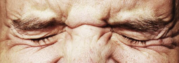 wrinkled closed eyes squinting