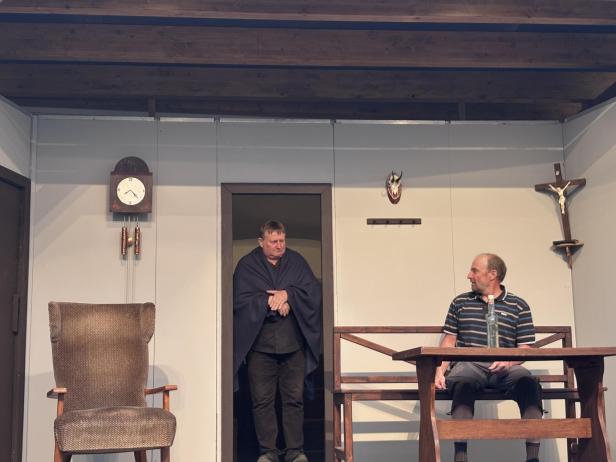 Zwei Männer spielen auf einer Bühne Theater.