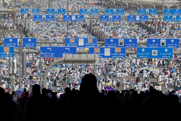 Muslim pilgrims walk on the first day of the Satan stoning ritual, in Mina