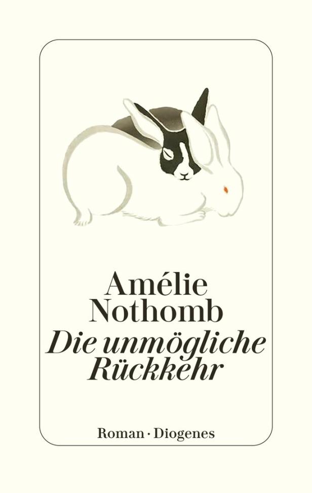 Zwei Kaninchen liegen eng beieinander, eines davon hat ein schwarz-weißes Gesicht.