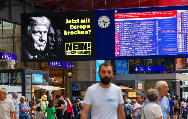 Adverts featuring portraits of Trump, Putin and Xi asking to vote "No" to June 14 vote urging voters to reject a proposal are displayed in Zurich