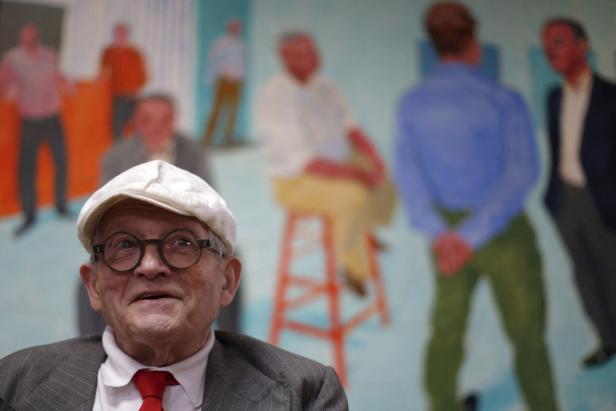 FILE PHOTO: British artist David Hockney is interviewed in front of his painting "The Group V" at a preview of his exhibition "Painting and Photography" at the L.A. Louver gallery in Venice, Los Angeles