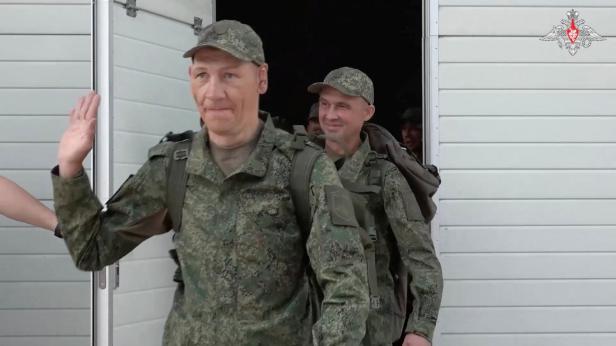 Freed Russian prisoners of war board a bus in Belarus
