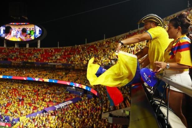Man sieht Fans mit einer kolumbianischen Flagge in einem Stadion
