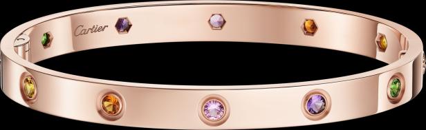 Roségoldenes Cartier-Armband mit bunten Edelsteinen auf schwarzem Hintergrund.
