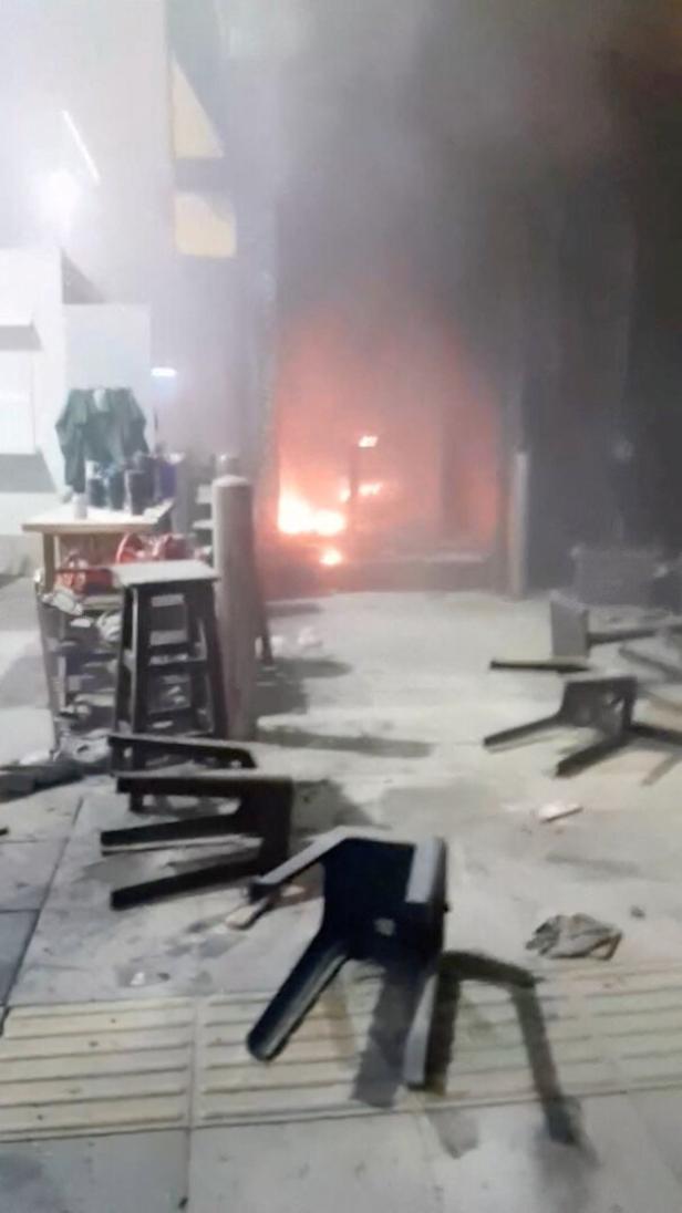 Flames and smoke rise at a pub in Bangkok