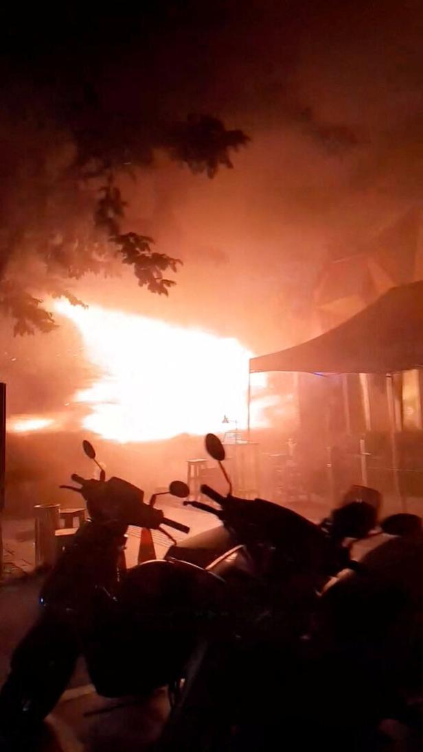 Flames rise at a pub in Bangkok