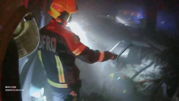 Rescue workers at the site of a deadly fire at a pub in Bangkok