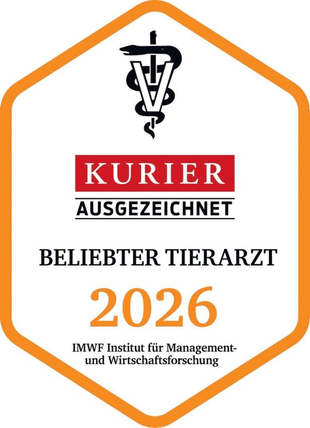 Ein sechseckiges Siegel des Kurier und des IMWF für die Auszeichnung „Beliebter Tierarzt 2026“ mit einem Äskulapstab-Symbol.