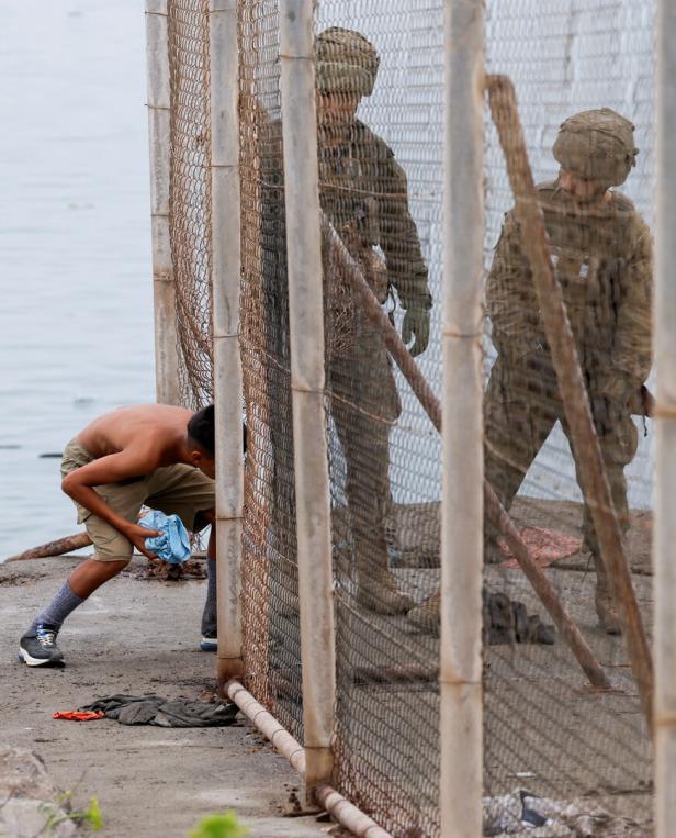 Migrants cross into the Spanish enclave of Ceuta