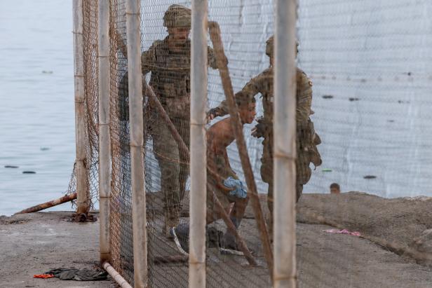 Migrants cross into the Spanish enclave of Ceuta