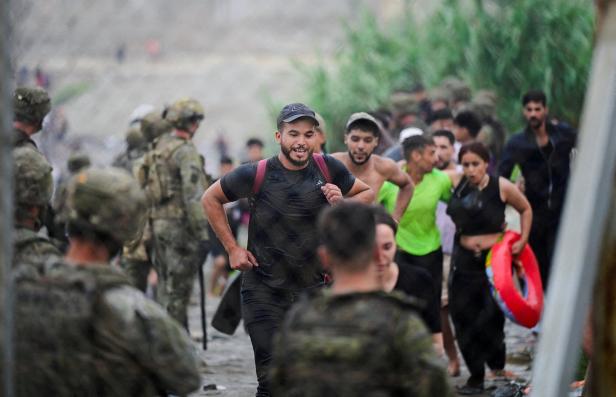 Migrants from Morocco arrive at the Spanish border in Ceuta