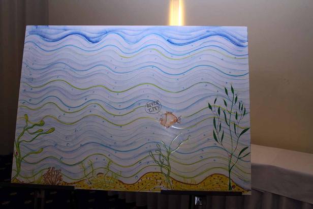 Eine Zeichnung zeigt eine Unterwasserlandschaft mit einem Fisch, der „River City“ denkt.