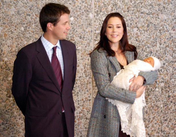 Mary, Kronprinzessin von Dänemark, hält ihr neugeborenes Kind im Arm, während Prinz Frederik sie ansieht.