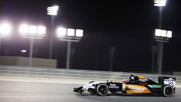 Ein Formel-1-Rennwagen fährt nachts unter Flutlicht auf einer Rennstrecke.