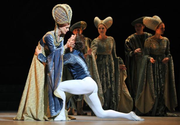 Eine Ballettszene mit Tänzern in historischen Kostümen auf einer Bühne.