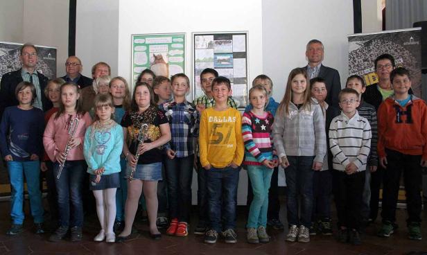 Eine Gruppe von Kindern und Erwachsenen posiert für ein Gruppenfoto.