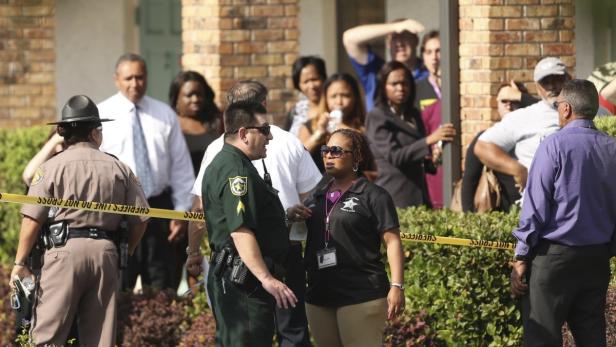 Parents wait behind as police consult after severa