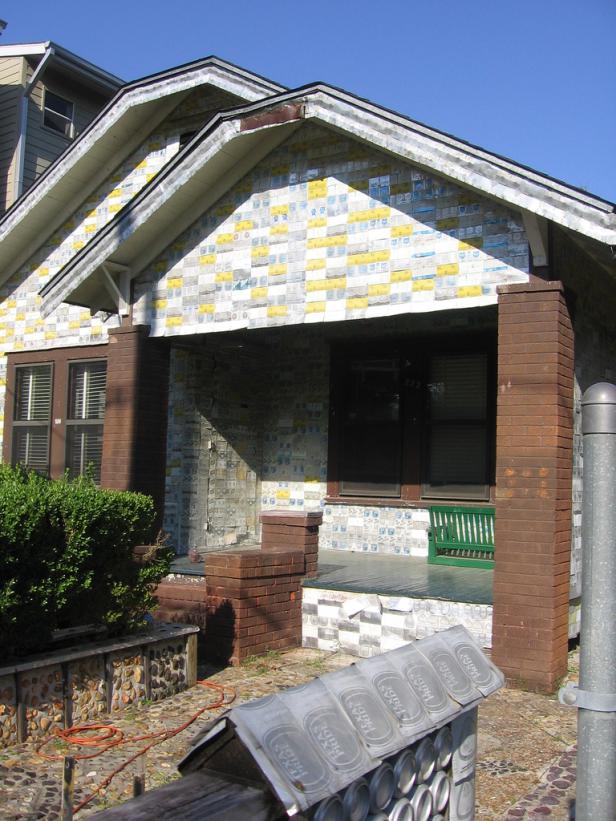 Ein Haus, dessen Fassade mit Bierdosen verkleidet ist.