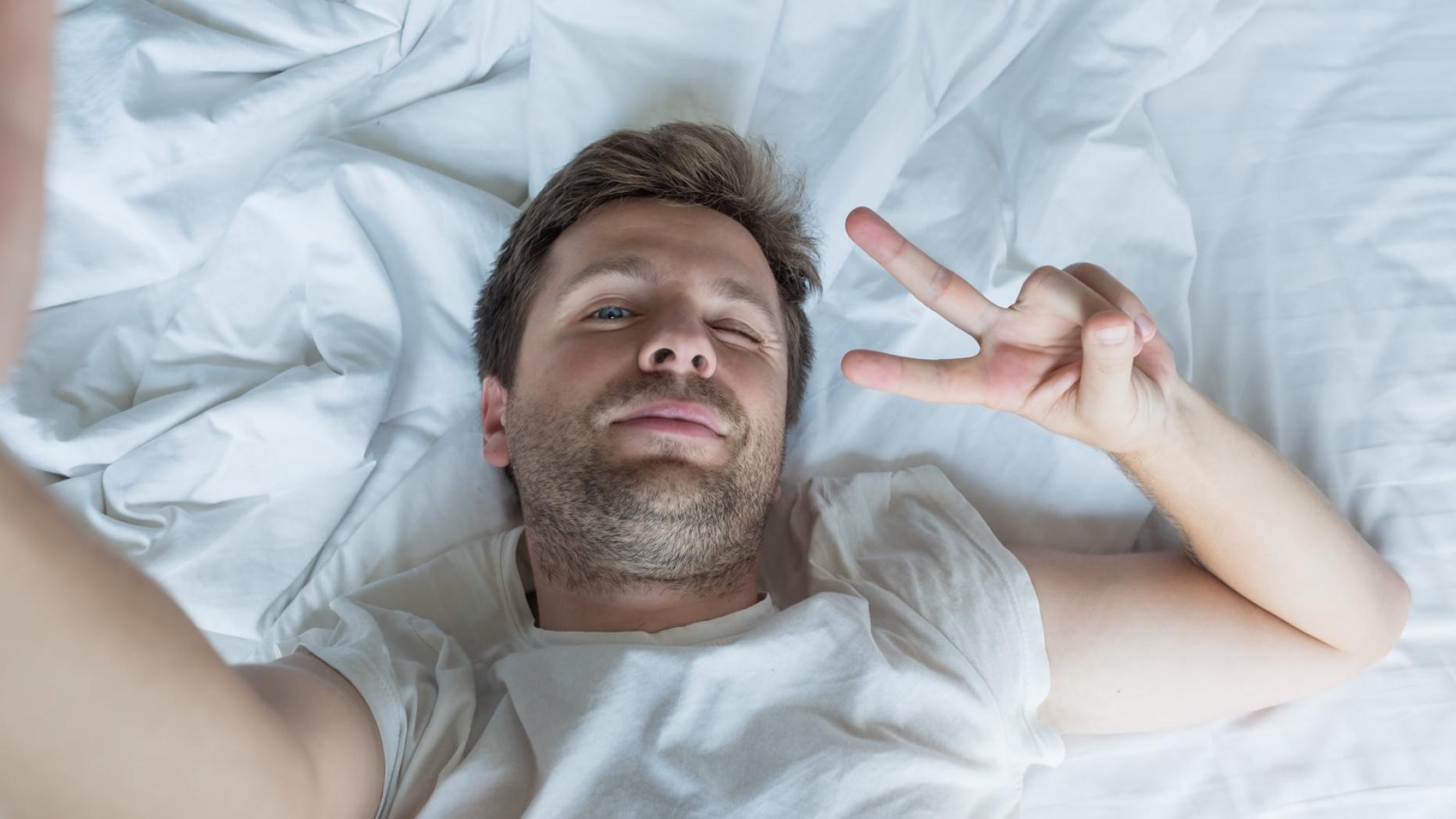 Man lying in bed selfie