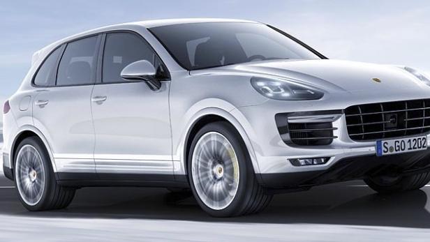 Ein weißer Porsche Cayenne fährt auf einer schneebedeckten Straße.