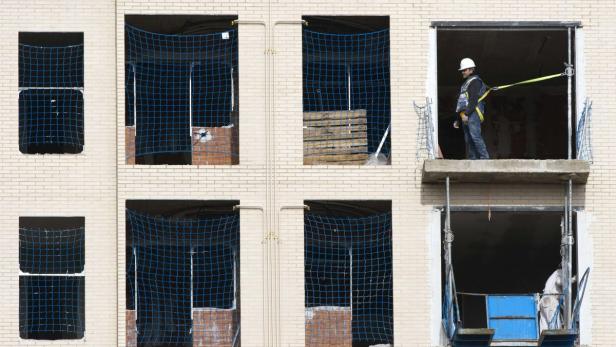 A construction worker pauses during works on an un